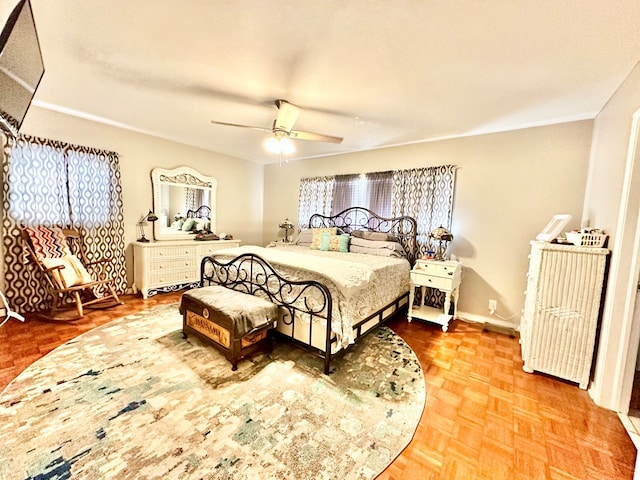 bedroom featuring ceiling fan and parquet flooring