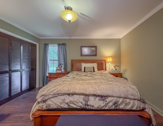 bedroom with a closet, baseboards, ornamental molding, and dark wood-style floors