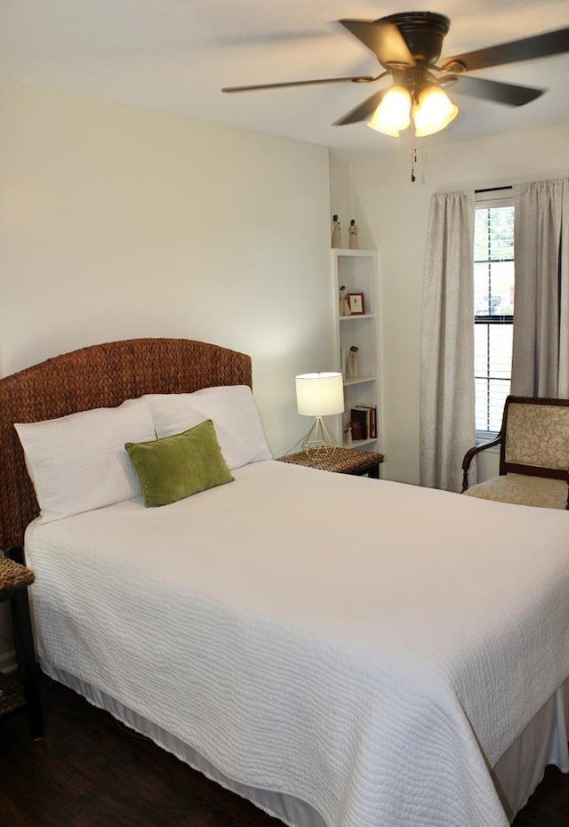 bedroom with a ceiling fan and wood finished floors