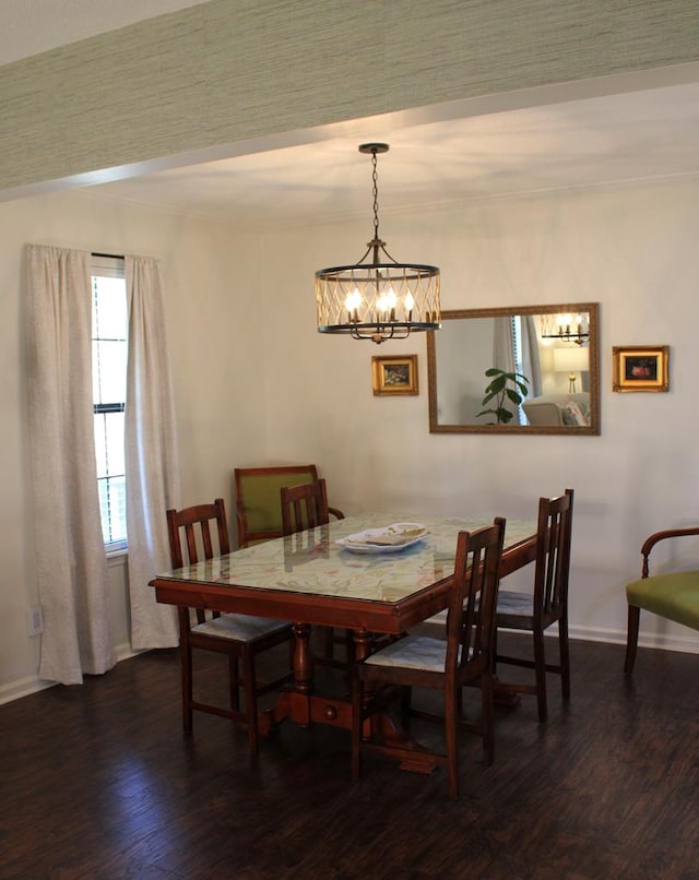 dining room featuring dark wood-style flooring, crown molding, and baseboards