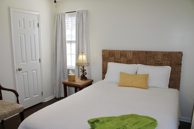 bedroom featuring dark wood-style flooring