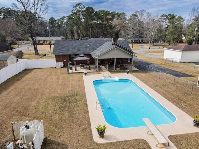 view of swimming pool featuring a fenced in pool, a fenced backyard, a gazebo, a yard, and a diving board