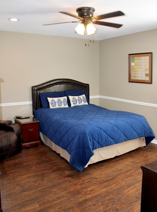 bedroom featuring a ceiling fan and dark wood-style flooring