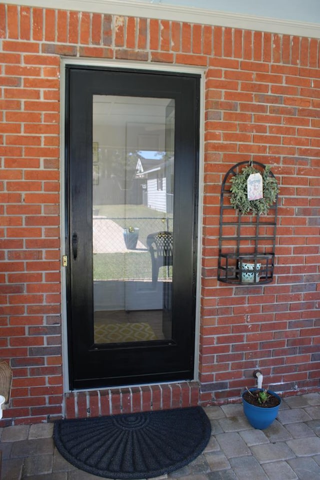 entrance to property with brick siding