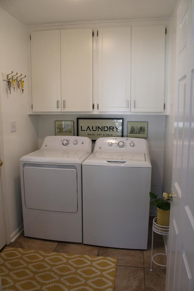 washroom featuring cabinet space, separate washer and dryer, and tile patterned floors