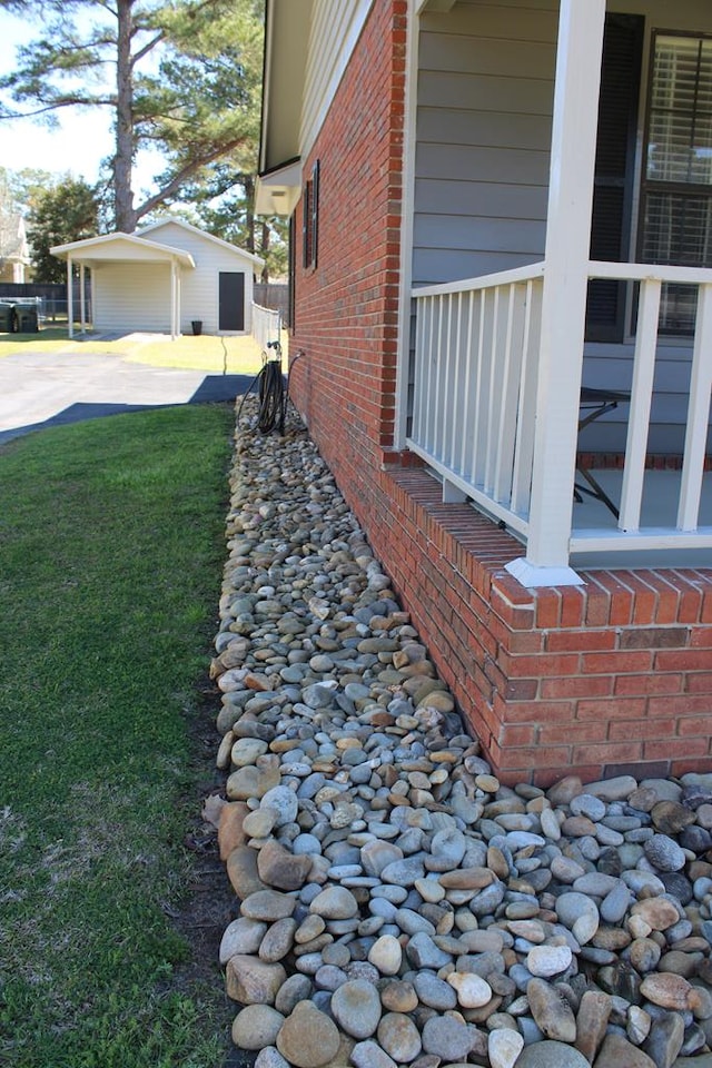 view of property exterior featuring brick siding and a yard