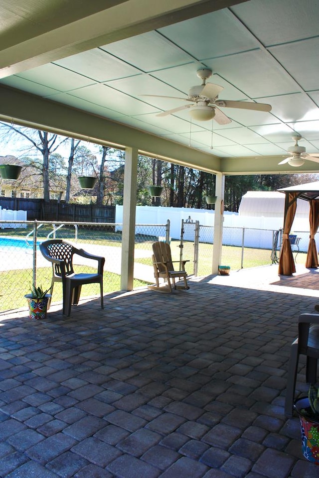 view of patio / terrace featuring a fenced in pool, a fenced backyard, and ceiling fan