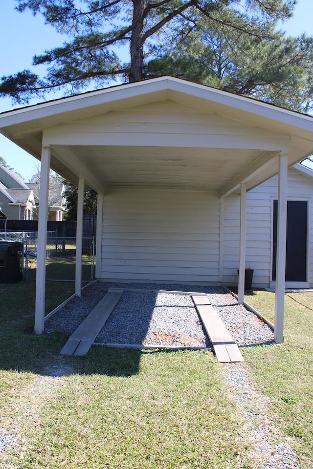 view of car parking featuring a carport and fence