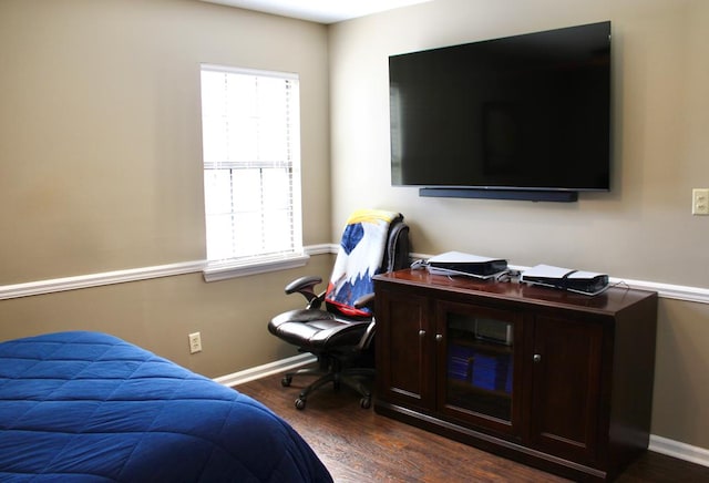 bedroom featuring dark wood-style floors and baseboards