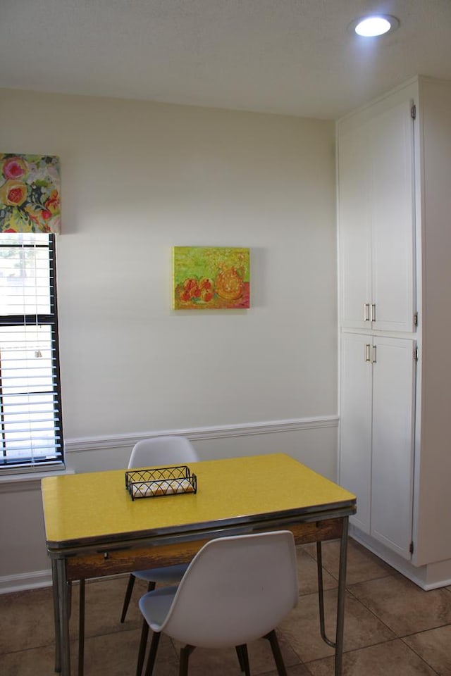 office with dark tile patterned floors and recessed lighting