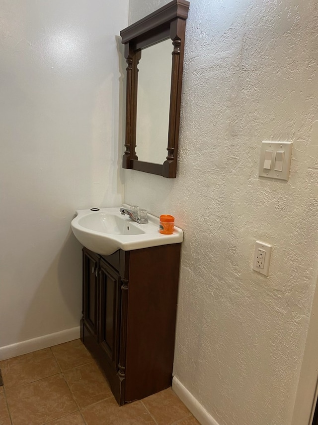 709 E College St, Bainbridge, GA 39817 - bathroom featuring vanity, tile patterned flooring, and baseboards