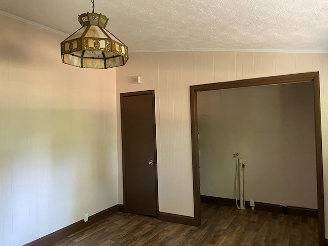 709 E College St, Bainbridge, GA 39817 - unfurnished room featuring dark wood-type flooring, crown molding, baseboards, and a textured ceiling