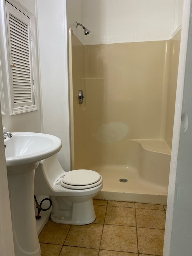709 E College St, Bainbridge, GA 39817 - bathroom with a shower stall, tile patterned floors, and toilet