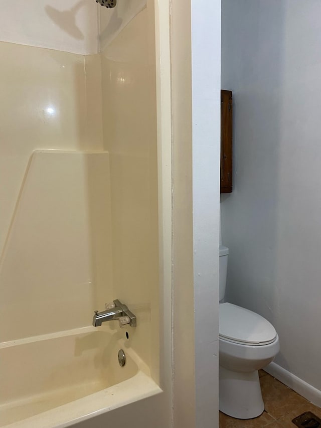 709 E College St, Bainbridge, GA 39817 - full bath with toilet, shower / bath combination, tile patterned flooring, and baseboards