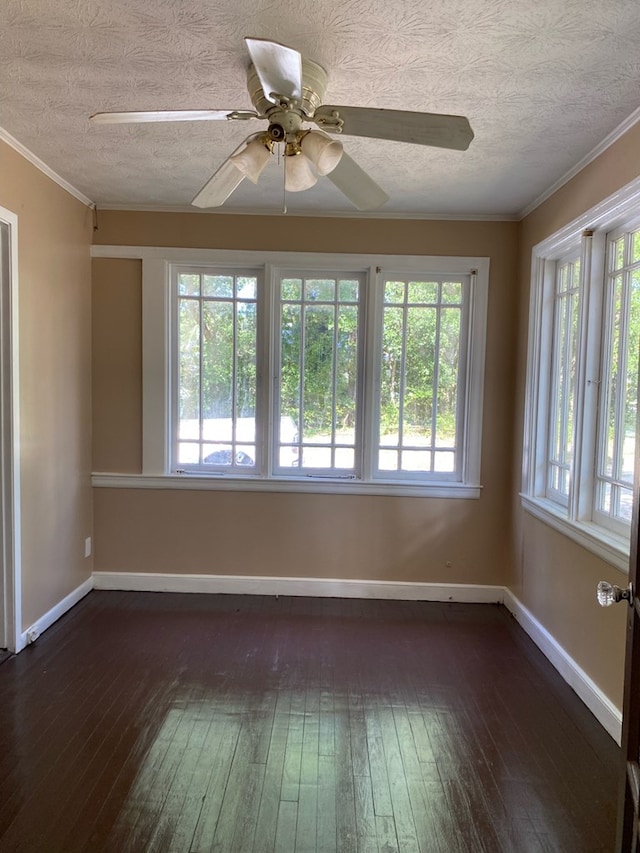 709 E College St, Bainbridge, GA 39817 - spare room featuring dark wood-style floors, baseboards, a textured ceiling, a ceiling fan, and crown molding