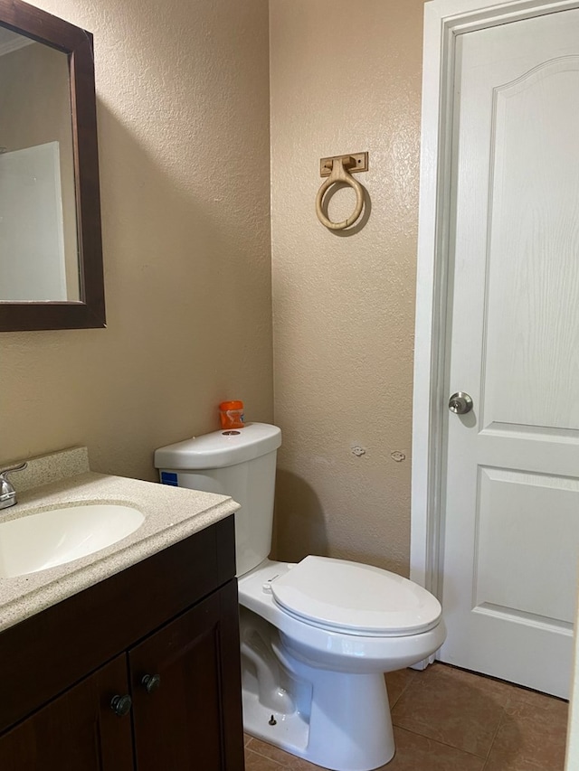 709 E College St, Bainbridge, GA 39817 - half bath with vanity, toilet, tile patterned floors, and a textured wall