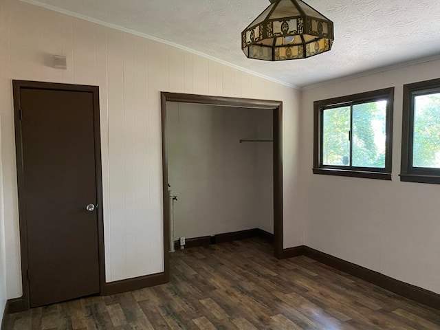 709 E College St, Bainbridge, GA 39817 - unfurnished bedroom with ornamental molding, dark wood finished floors, a closet, and baseboards