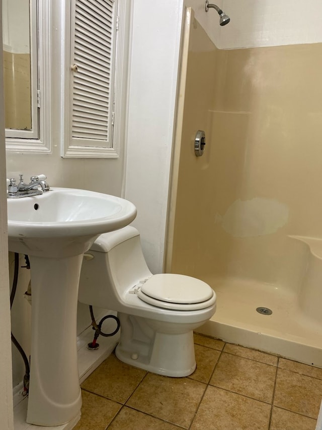 709 E College St, Bainbridge, GA 39817 - bathroom featuring a shower stall, toilet, and tile patterned flooring
