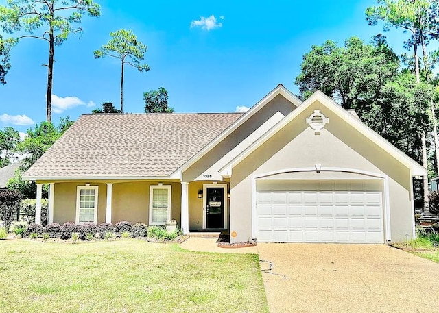 view of front of property with a garage and a front lawn