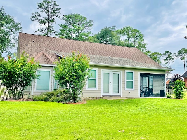 back of property featuring a lawn