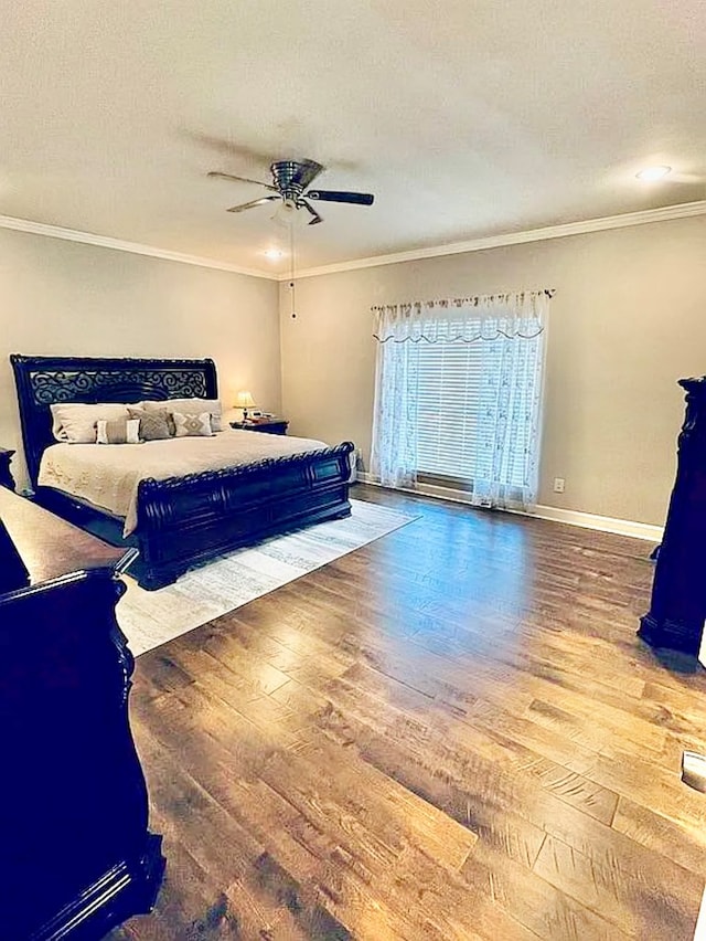 bedroom featuring hardwood / wood-style flooring, ceiling fan, and ornamental molding