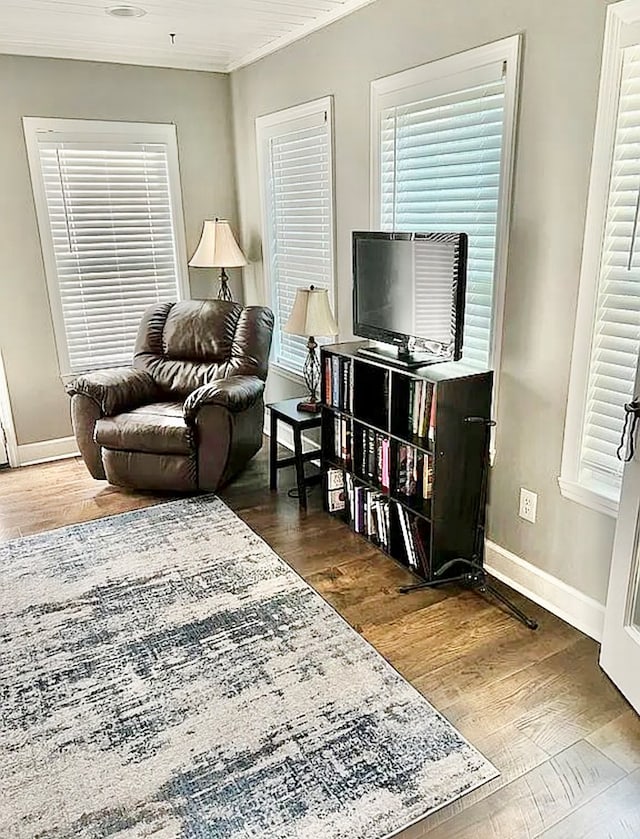 living room featuring crown molding and dark hardwood / wood-style flooring