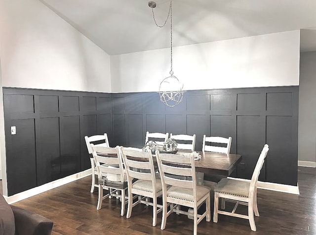 dining area featuring dark wood-type flooring and an inviting chandelier