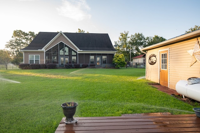 8030 Northwood Dr, Donalsonville, GA 39845 - rear view of property with a sunroom and a yard