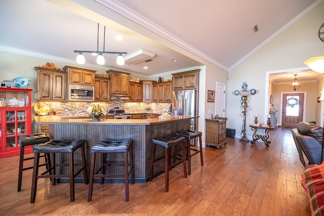 8030 Northwood Dr, Donalsonville, GA 39845 - kitchen featuring dark hardwood / wood-style flooring, stainless steel appliances, and crown molding
