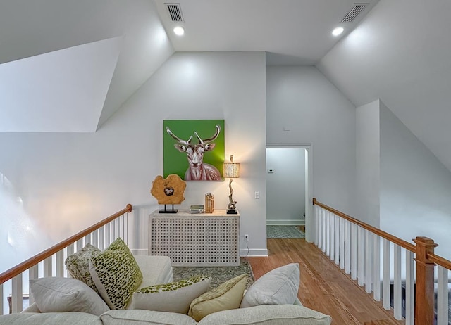 interior space with light hardwood / wood-style floors and vaulted ceiling