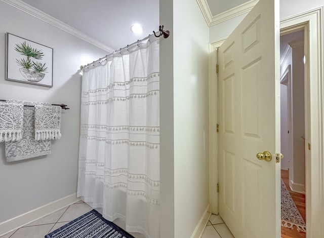 bathroom featuring tile patterned floors, crown molding, and shower / tub combo with curtain