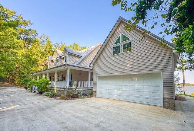 view of front of property featuring covered porch and a garage