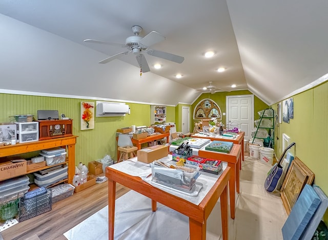 rec room featuring ceiling fan, light hardwood / wood-style flooring, a wall unit AC, and vaulted ceiling