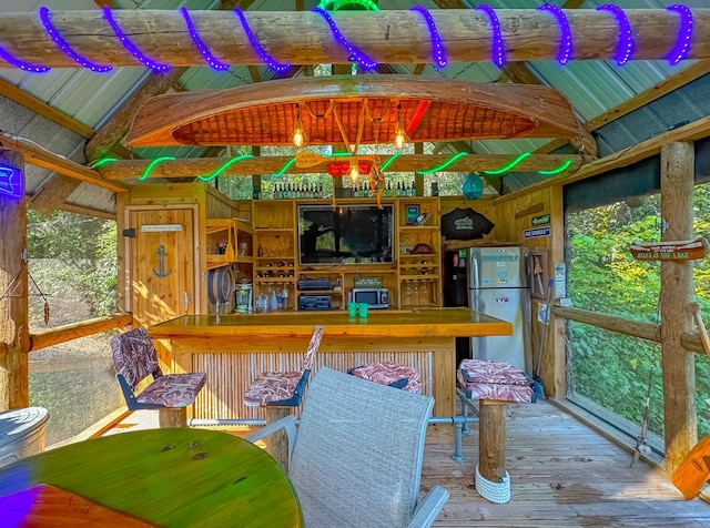 sunroom / solarium featuring vaulted ceiling