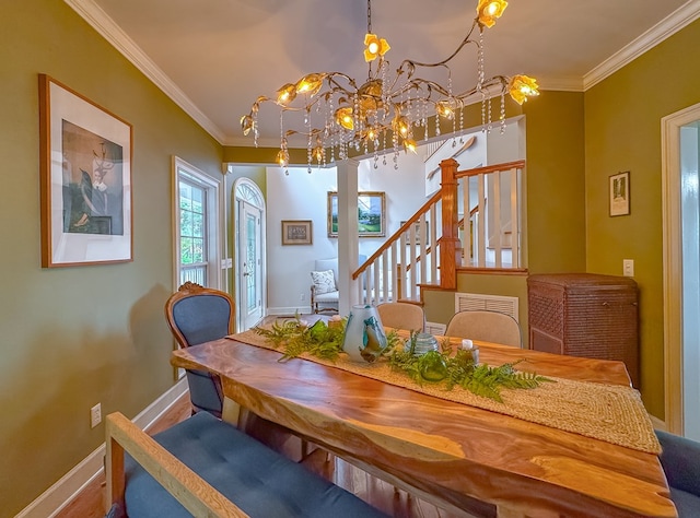 dining room with a chandelier and crown molding