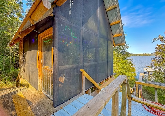 exterior space featuring a deck with water view