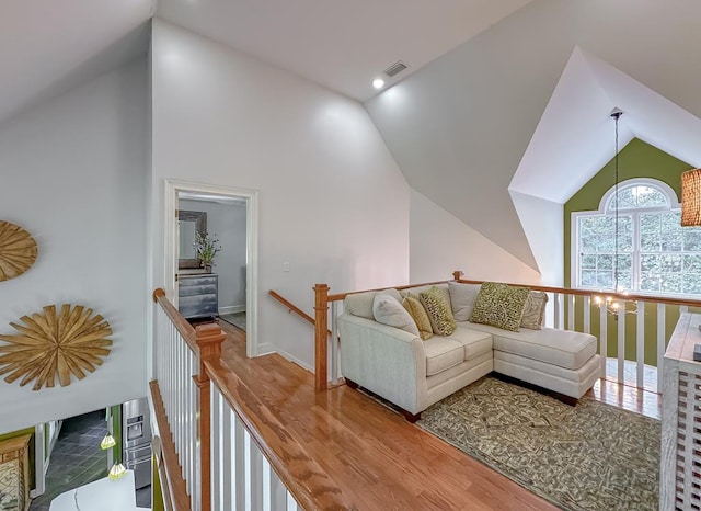 living room featuring lofted ceiling and hardwood / wood-style flooring