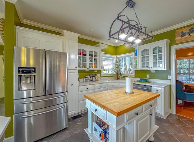 kitchen with a center island, white cabinetry, stainless steel appliances, and a wealth of natural light