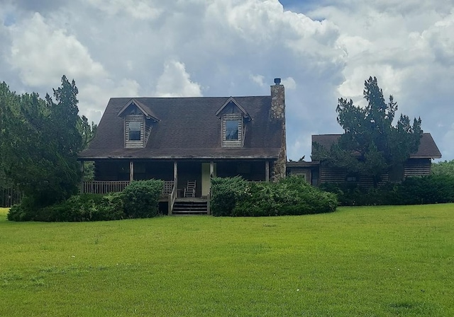 1210 Elkins Rd, Cairo, GA 39827 - view of front facade featuring a front yard, covered porch, and a chimney