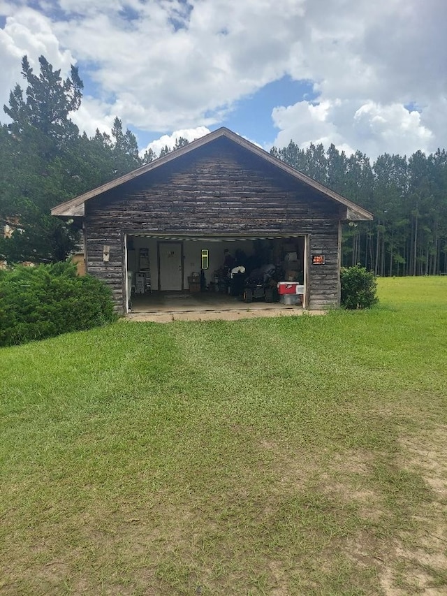 1210 Elkins Rd, Cairo, GA 39827 - view of side of home featuring a lawn and a garage
