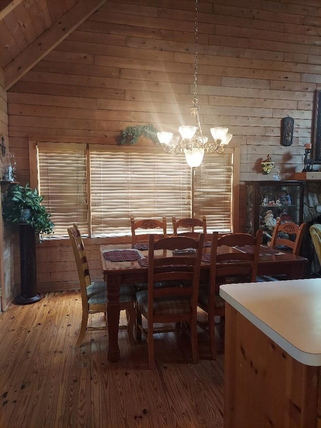 1210 Elkins Rd, Cairo, GA 39827 - dining room with light wood-style flooring, a chandelier, wood walls, and wooden ceiling