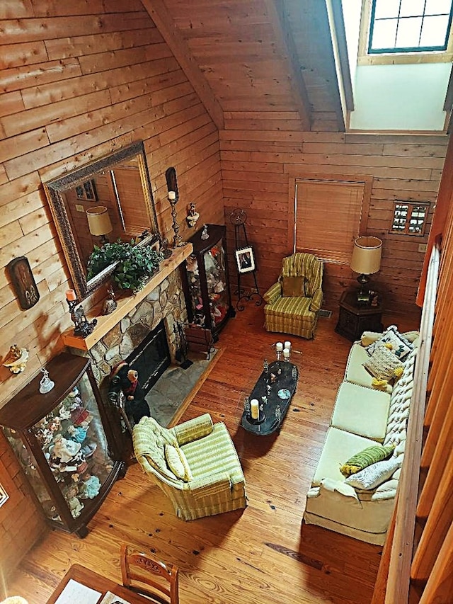 1210 Elkins Rd, Cairo, GA 39827 - living area with hardwood / wood-style flooring, wooden walls, a fireplace, and a wooden ceiling with exposed beams