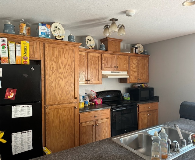 kitchen featuring sink, a textured ceiling, and black appliances