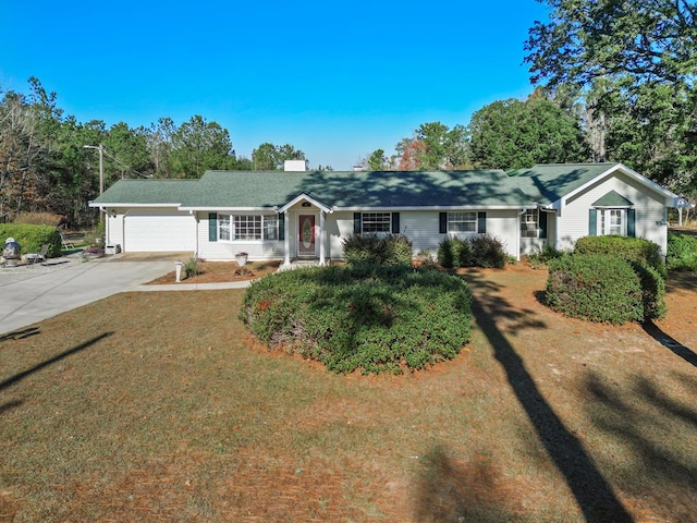 single story home featuring a front lawn and a garage