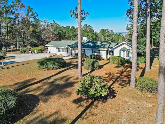 ranch-style house with a garage and a front lawn