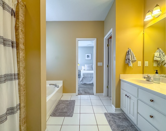 bathroom featuring a bathing tub, vanity, and tile patterned floors