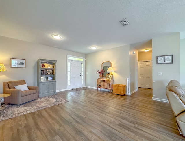 sitting room with a textured ceiling and hardwood / wood-style floors