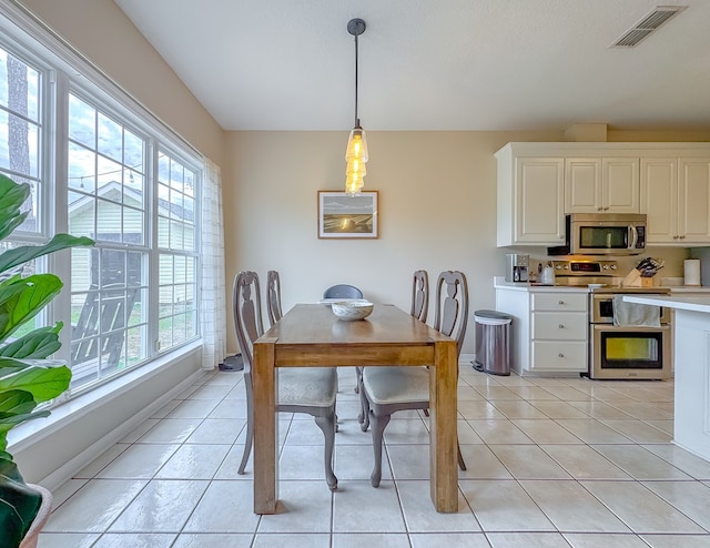 dining space featuring light tile patterned floors