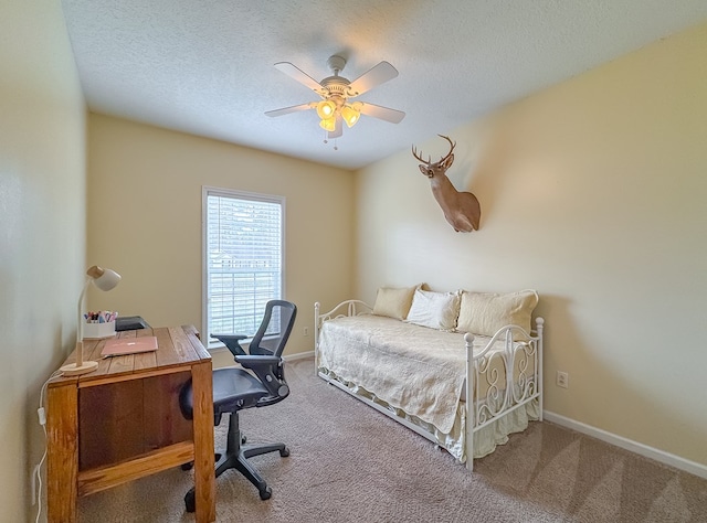 bedroom featuring ceiling fan, carpet flooring, and a textured ceiling