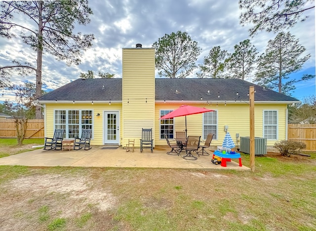 rear view of house featuring central AC unit and a patio